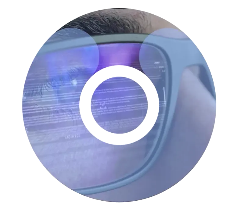 A close-up of a person wearing augmented reality glasses, displaying lines of code and data overlays on a blue-tinted digital interface. The data appears to be related to manufacturing execution system (MES) information.