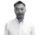 Headshot of Kenzo Takai, Manufacturo's Chief Operations Officer, a middle-aged East Asian man with short dark hair, a goatee, and a slight smile, wearing a white collared shirt against a white background.