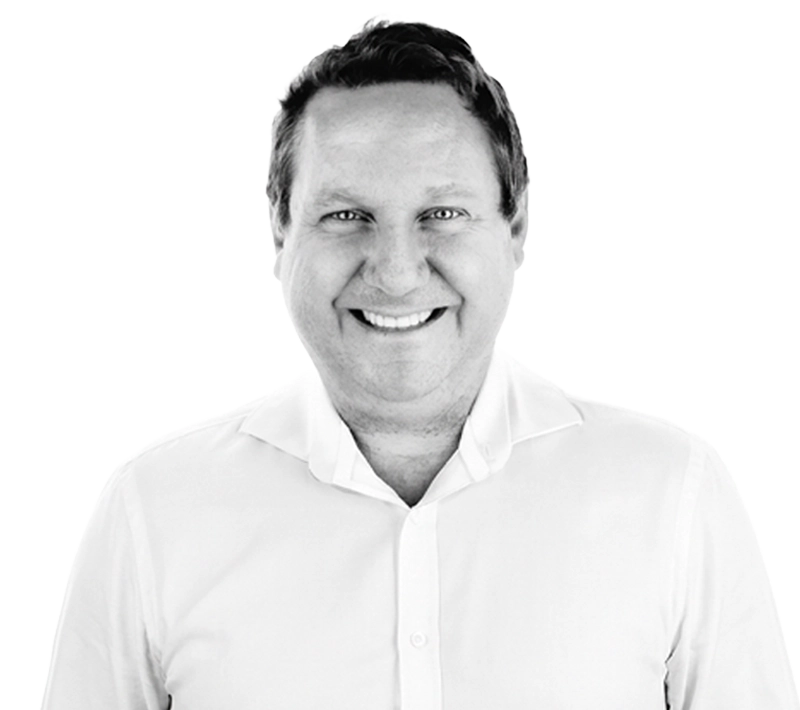 Smiling man, James Montgomery, in a white shirt, looking directly at the viewer with a friendly expression. He has short, dark hair and a light complexion, set against a plain white background for clarity.