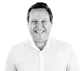Smiling man, James Montgomery, in a white shirt, looking directly at the viewer with a friendly expression. He has short, dark hair and a light complexion, set against a plain white background for clarity.