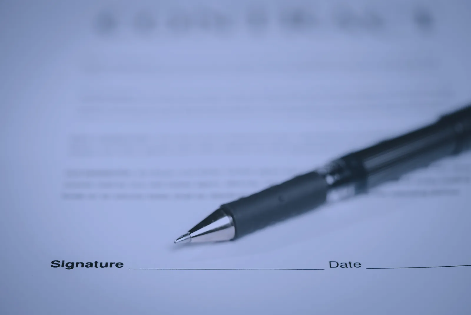 Pen on agreement document signature line – lavender
